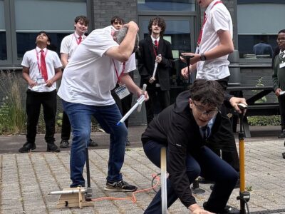 16 - Aras from Newmarket Academy launches his paper rocket as another returns to earth